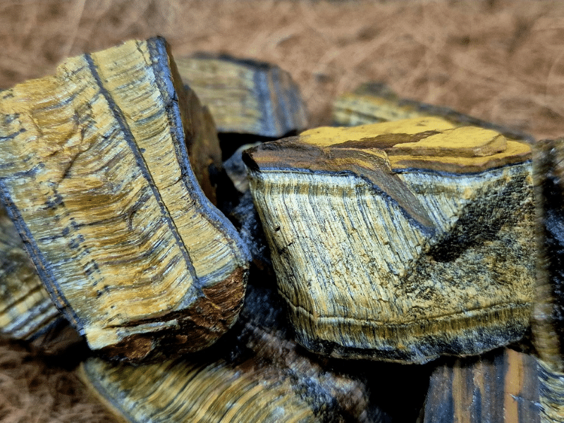 Close-up of raw Tiger’s Eye crystal with natural golden-brown banding